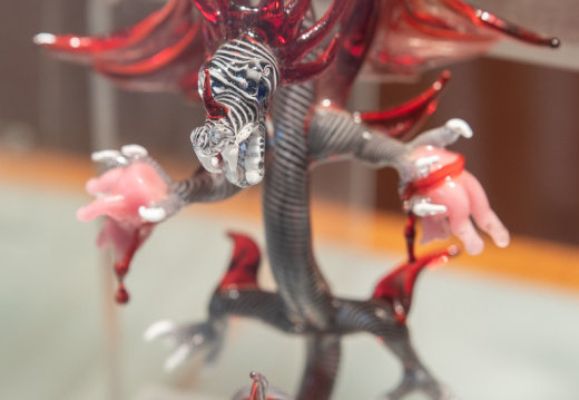 Glass dragon tearing apart pig